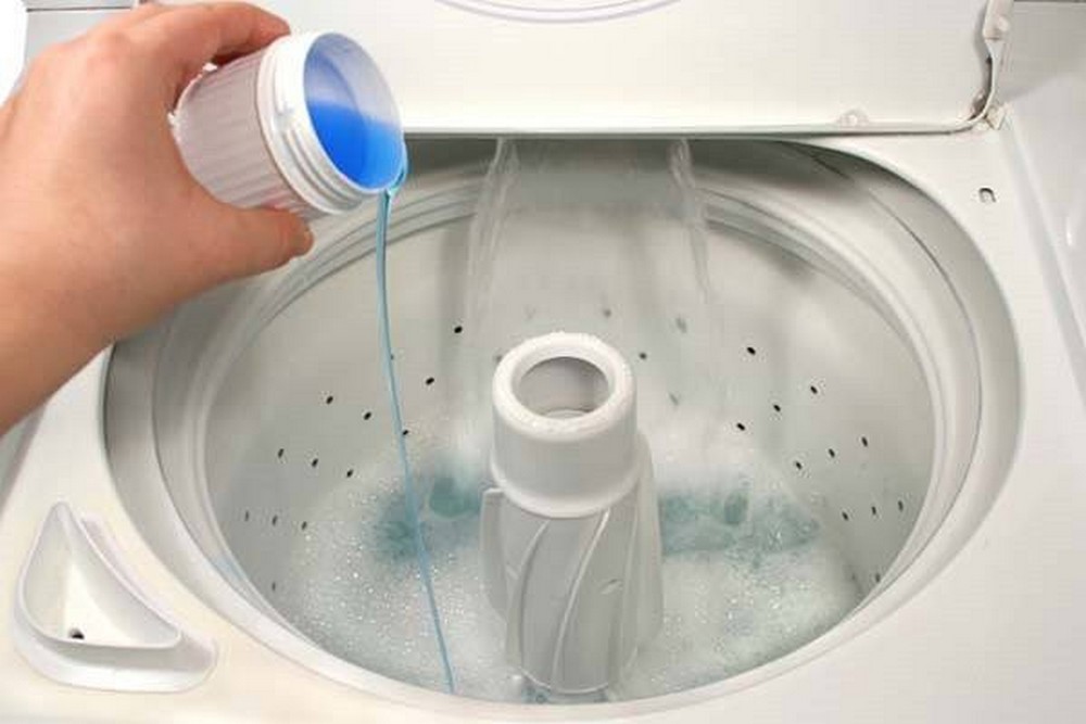 Pouring Liquid Detergent Inside Drum