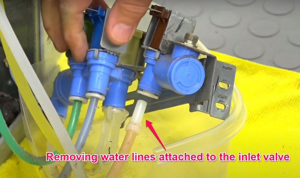 Removing water lines attached to the inlet valve
