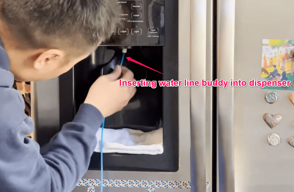 Inserting Water Line Buddy into Dispenser Fridge